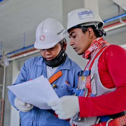 Two Man Holding White Paper